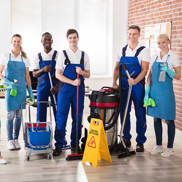 Men and women smiling happily with cleaning equipments
