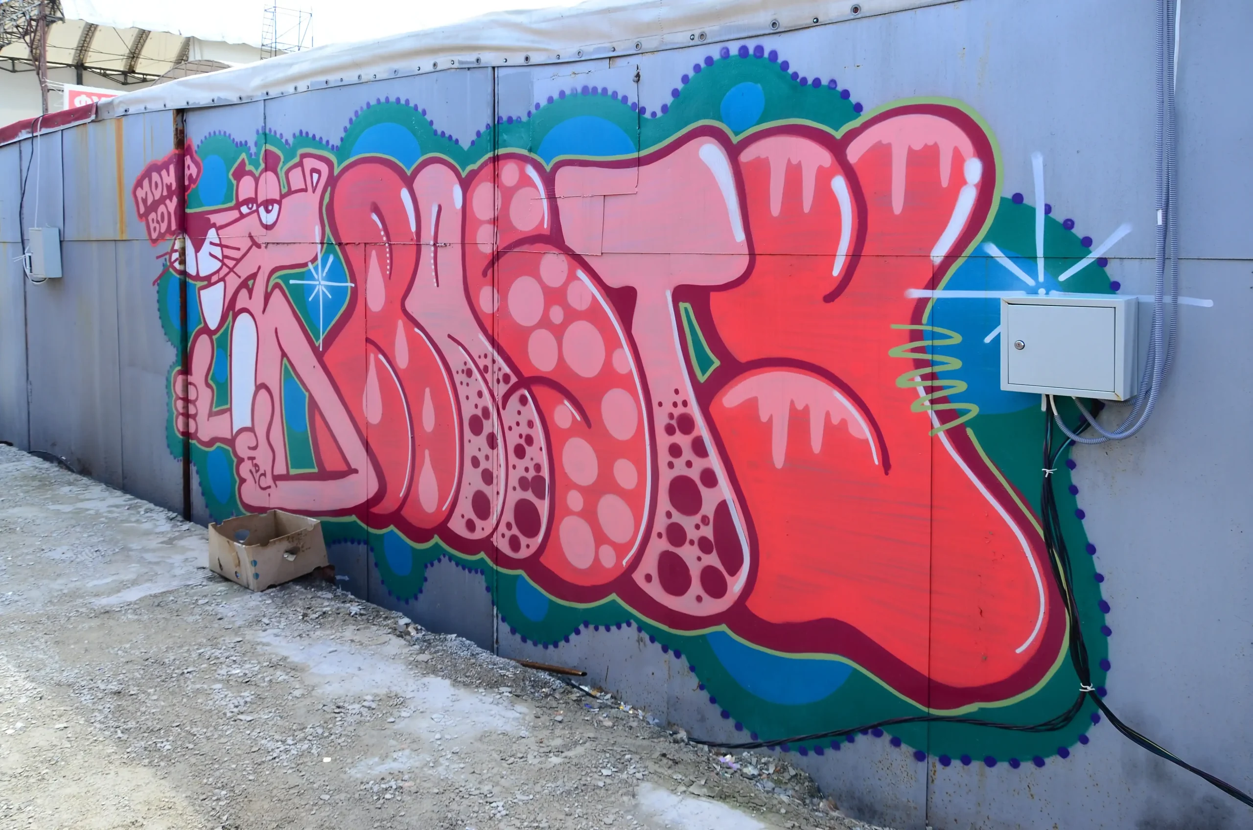 South Florida metal fence wall covered with spray paint graffiti before pressure cleaning service